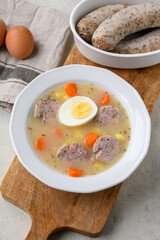 Sour soup with sausage and egg, traditional Polish soup