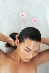Caucasian Woman Wringing Wet Hair in Bathtub, Spa and Skincare Concept Photo