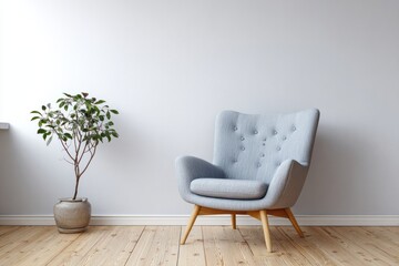 Minimalist room with a light blue armchair and potted plant.