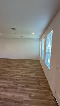 Empty House Interior Open Concept Living Room and Kitchen with Wood Flooring.  