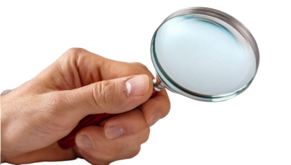 Hand holding a magnifying glass against an isolated background. 