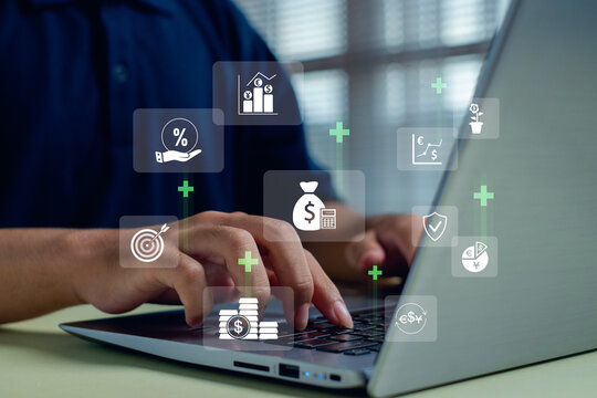 Hands typing on a laptop with floating financial icons, illustrating digital finance, investment planning, online banking, and modern money management in today’s technology-driven economy.