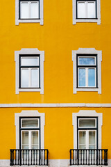 Fototapeta premium Typical old buildings in Lisbon's lower town, with their windows with balconies, lanterns, and decorative tiles. Lisbon, Portugal, 2023