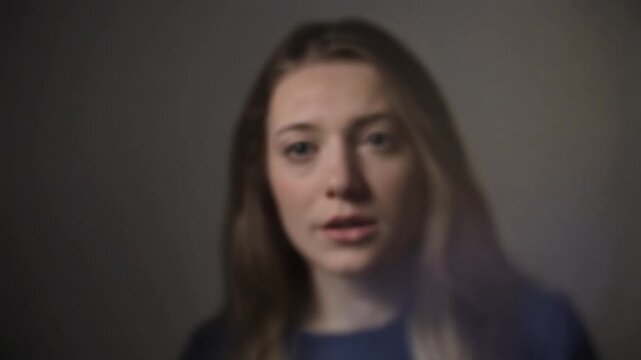 person appears out of focus in front of the camera, creating a sense of confusion