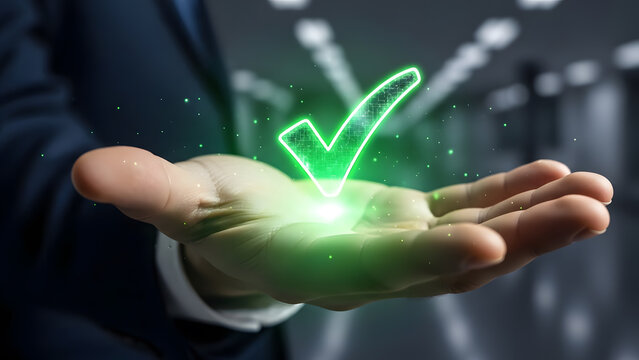 Businessman holding glowing green checkmark symbol in hand for approval concept