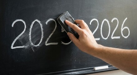 Hand Erasing 2025 From Blackboard Revealing 2026 In Chalk With Dust Particles Floating