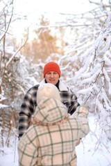 Father and daughter playing and enjoying the snow in a winter forest. Concept of family joy, warm emotions, childlike happiness, and fun winter activities outdoors.
