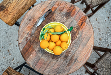 top view of a wooden table with freshly picked organic oranges ready to serve