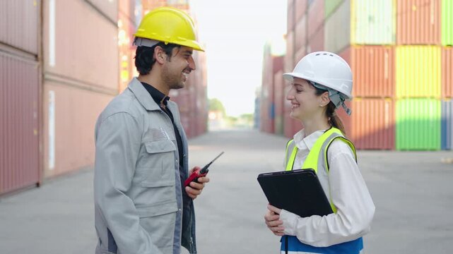 A female and male engineer and foreman team share a warm handshake amidst the busy shipyard filled with colorful cargo containers. Safety is a priority as they oversee loading operations.
