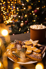 Lots of gingerbread cookies for Christmas in a plate on a dark background. Homemade gingerbread cookies for Christmas holiday