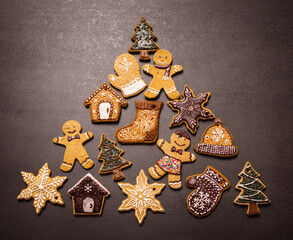 Lots of gingerbread cookies for Christmas in a plate on a dark background. Homemade gingerbread cookies for Christmas holiday