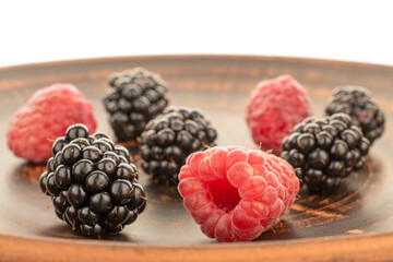 Sweet raspberries and blackberries isolated on white background, macro.
