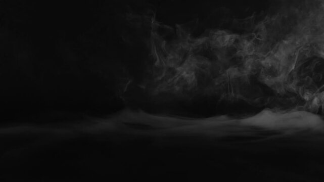Wispy white smoke swirling on a dark background mist