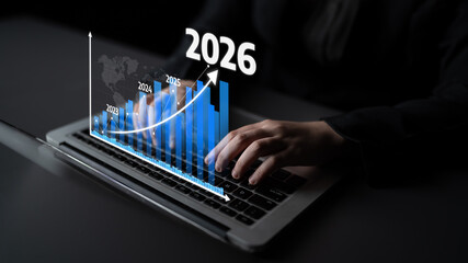 A business professional engages with financial data on a laptop, showcasing graphical growth projections from 2023 to 2026, highlighting trends and analytics. Tessel