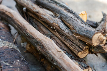 Stack of dry firewood logs close up