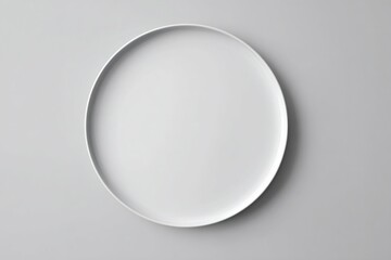 White round plate resting on a gray background, offering minimal copy space for food and culinary design presentations