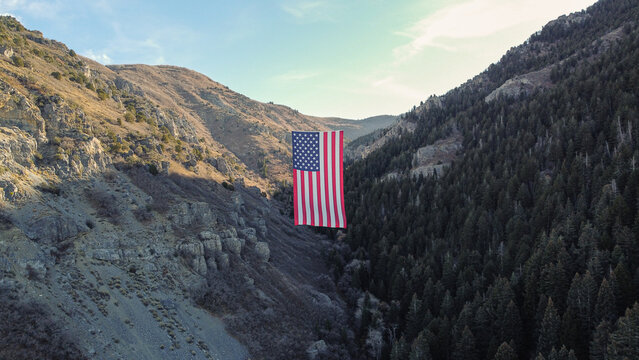 Aerial Drone Views of The Major Large American Flag Hanging in Mountains of North Ogden Utah Veterans Day 
