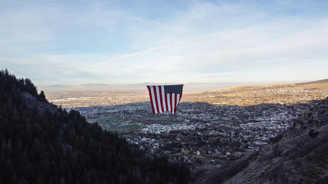 Aerial Drone Views of The Major Large American Flag Hanging in Mountains of North Ogden Utah Veterans Day 