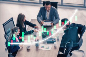 A diverse group of business professionals engaged in a collaborative meeting focused on data analysis. The digital growth graph illustrates emerging trends and insights. Impute