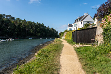 A river runs through a town with a house on the bank