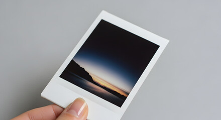 Instant photo of coastal twilight, minimalist gray backdrop, nostalgic travel memory with copy space