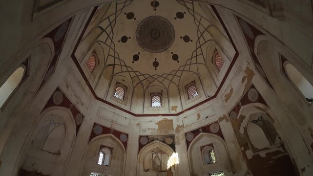 Interior Perspective of the Nila Gumbad (Blue Dome) Tomb, Capturing the Intricate Geometric Patterns and Artwork on the Ceiling Under Low Light, Highlighting Mughal-Era Heritage and Architecture