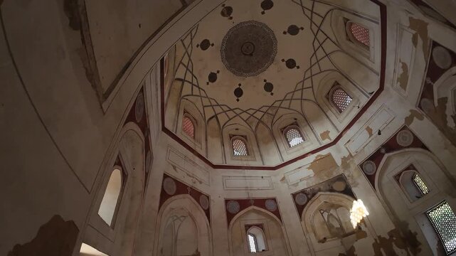 Interior Perspective of the Nila Gumbad (Blue Dome) Tomb, Capturing the Intricate Geometric Patterns and Artwork on the Ceiling Under Low Light, Highlighting Mughal-Era Heritage and Architecture