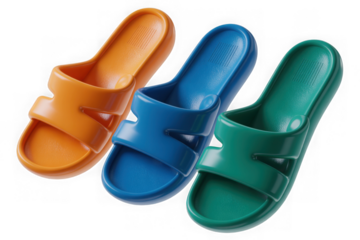 Three colorful slide sandals in orange, blue, and green arranged diagonally isolated on transparent background