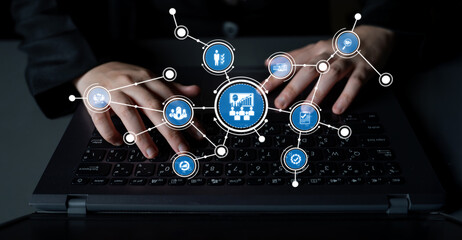 A close-up view of hands typing on a laptop keyboard with multiple icons symbolizing business analytics, data visualization, and digital transformation surrounding the screen. Tessel