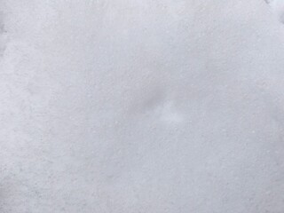 Winter texture. The surface of the snow. Winter background. A light backdrop. Top view.