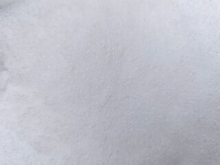 Winter texture. The surface of the snow. Winter background. A light backdrop. Top view.