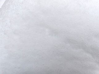 Winter texture. The surface of the snow. Winter background. A light backdrop. Top view.