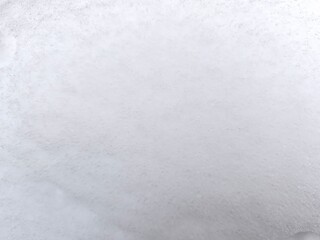 Winter texture. The surface of the snow. Winter background. A light backdrop. Top view.