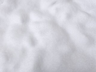 Naklejka premium Winter texture. The surface of the snow. Winter background. A light backdrop. Top view.