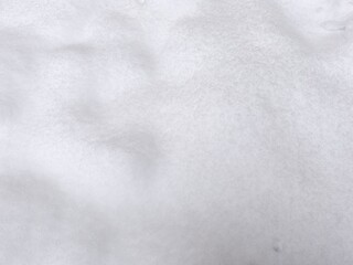 Winter texture. The surface of the snow. Winter background. A light backdrop. Top view.