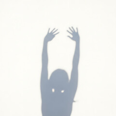 Obraz premium Shadow of a person reaching up with hands outstretched.