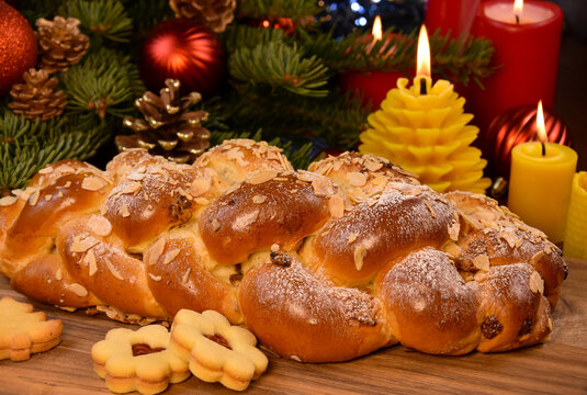 Vanocka sweet braided Christmas bread detail stock photo images. Czech Christmas pastry, cookies, candles and fir branches on wooden table closeup stock photo. Template for background, banner, card