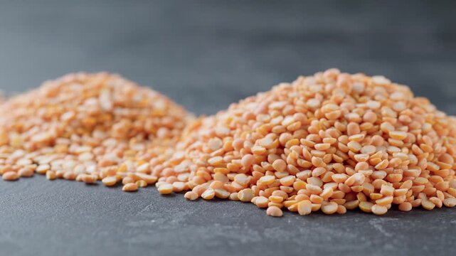 Pile of dried peas or yellow peas on a black marble background. 
 Heap of dry yellow peas on a dark kitchen table.