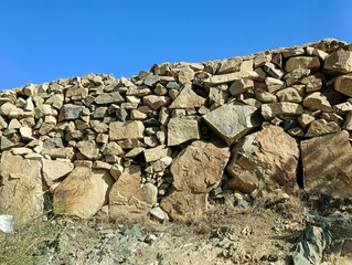 Ancient Stone Wall Under Clear Desert Sky