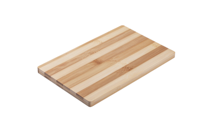Rectangular cutting board made of light and dark wood strips with rounded edges sits on a white background alpha channel