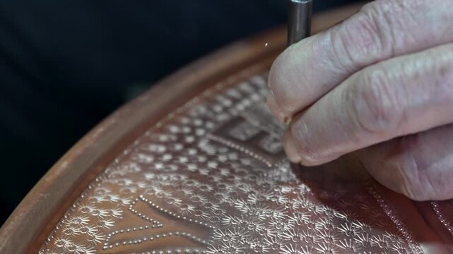 Close up view of traditional copper engraving being done by hand in an old Turkish bazaar in Gaziantep.