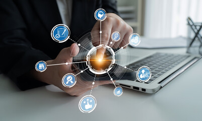 A business professional engages with a digital interface on a laptop, representing modern technology, connectivity, and efficiency in professional environments. Crux