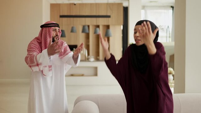 Displeased Muslim woman arguing with husband at home, relationship crisis