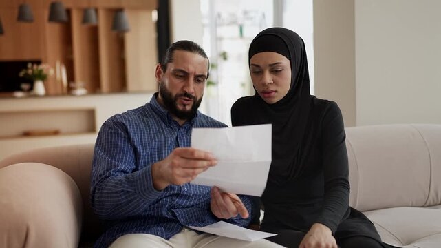 Young couple reading bad news letter, upset about immigration refusal