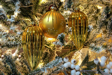 Golden Christmas ornaments on snowy branches in warm light
Golden Christmas ornaments resting on snowy branches, illuminated by warm winter light.

