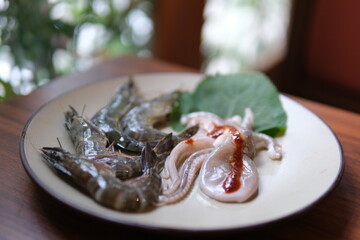 raw shrimp and octopus Seafood cocktail with octopus, shrimp, calamari and mussel