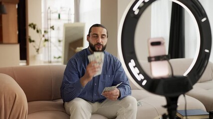 Successful young man recording financial blog on phone, sharing business tips