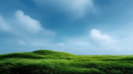 Fototapeta premium Tranquil Landscape with Green Grass Under a Clear Blue Sky and Soft White Clouds Perfect for Nature Themed Projects and Backgrounds