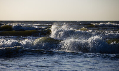 dark waves crashing on the beach on an evening