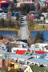 Road Leading Through Colorful Reykjav&iacute;k Houses Toward the Sea